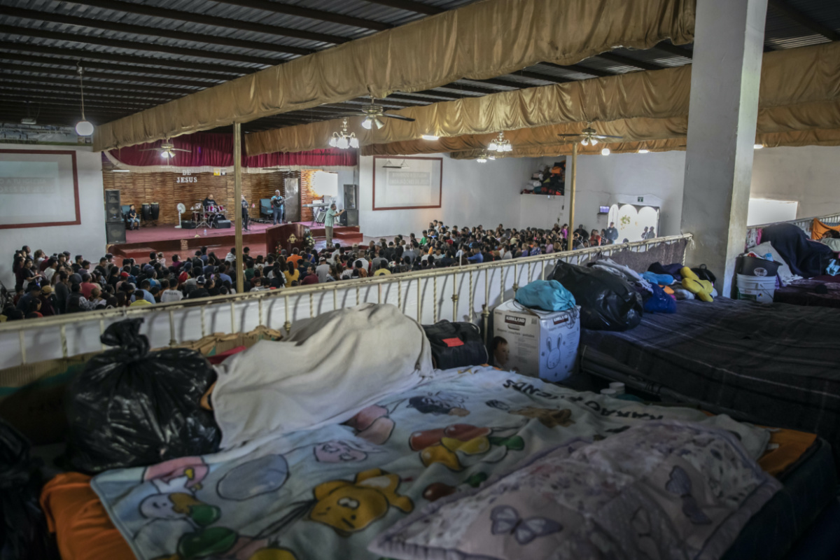 Beds cover an upper floor of the "Embajadores de Jesus" Christian migrant shelter as Mexican migrants, many from Michoacan state, attend a religious service on the bottom floor in Tijuana, Mexico, on Tuesday, 26th September, 2023