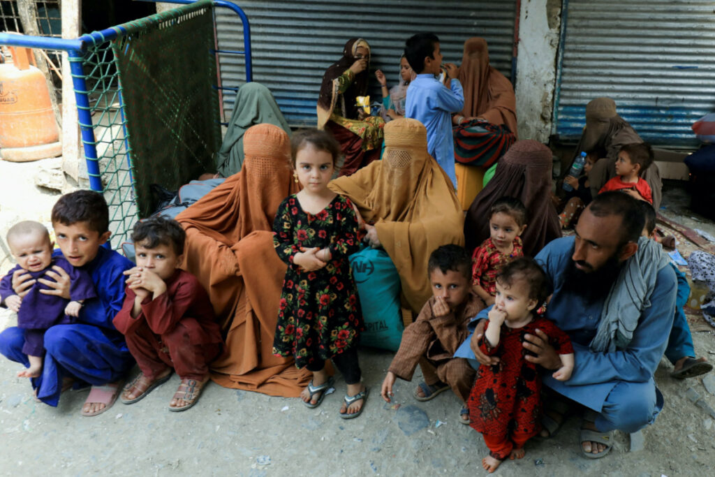 Muhammad Ismail, 40, sits with his family while they are waiting to cross main Afghanistan-Pakistan land border crossing, in Torkham, Pakistan, on 15th September, 2023