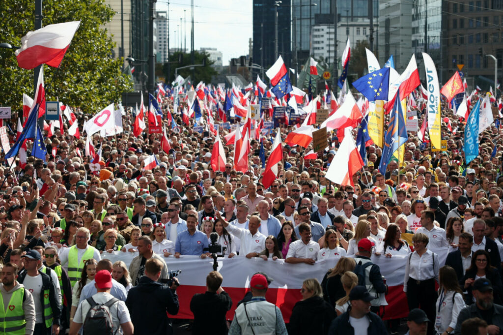 Donald Tusk, the leader of the largest opposition grouping Civic Coalition and Rafal Trzaskowski, Mayor of Warsaw march in front of the Polish national flag during the "Marsz Miliona Serc" rally, in Warsaw, Poland, on 1st October, 2023