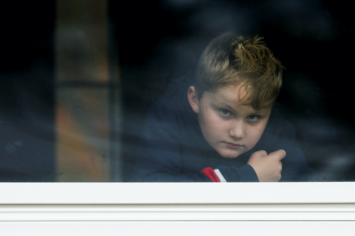 Dexter Britton, nine, looks out through a window as Lisbon Falls remains on lockdown, following a deadly mass shooting in Lewiston, in Lisbon Falls, Maine, US, on 26th October, 2023.