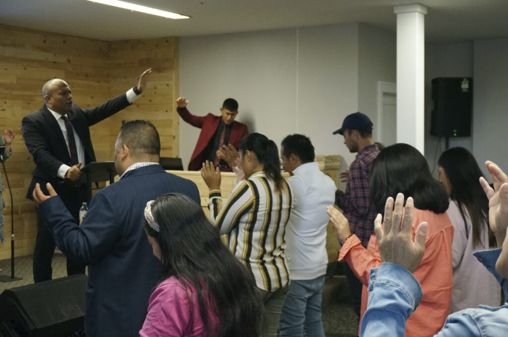 Rev Gustavo Castillo leads in song and praise members of his congregation at the Iglesia Pentecostal Unida Latinoamericana in Columbia Heights, Minn., on Sunday, 24th September, 2023.