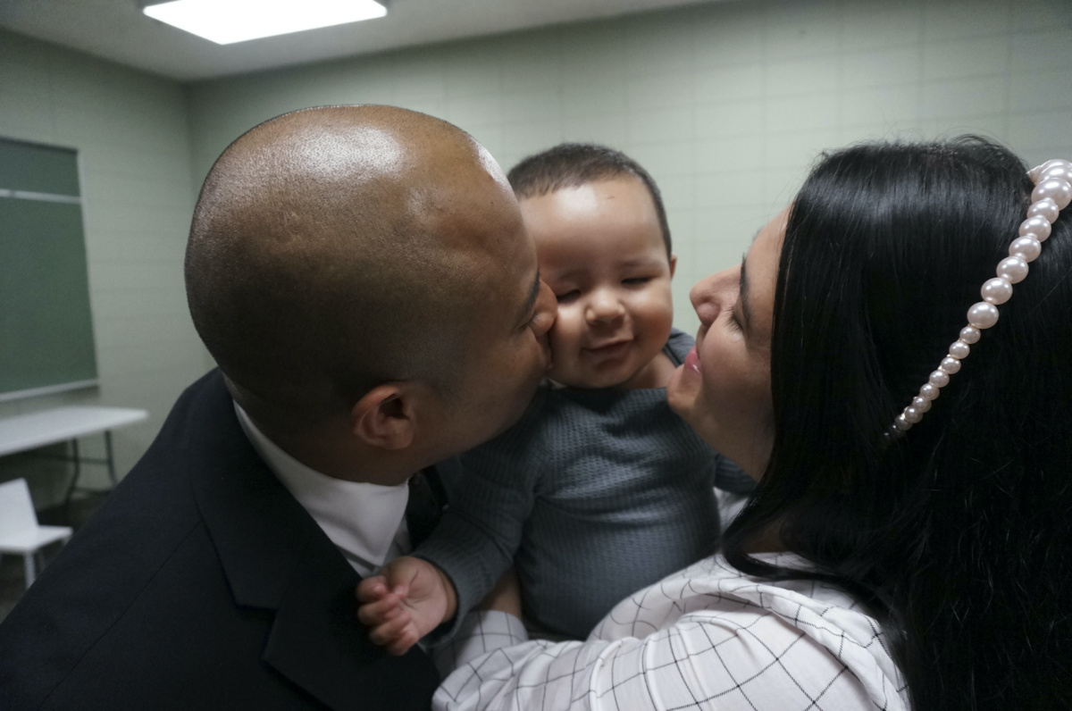 Rev Gustavo Castillo, left, and his wife, Yarleny, play with their seven-month-old son, Gustavo Jr, after a worship service at the Iglesia Pentecostal Unida Latinoamericana in Columbia Heights, Minnesota, on Sunday, 24th September, 2023