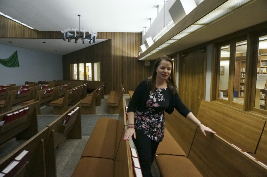 The Rev. Karna Moskalik walks through each line of pews in the sanctuary of Our Savior's Lutheran Church in Stillwater, Minn., on Wednesday, on 27th September, 2023