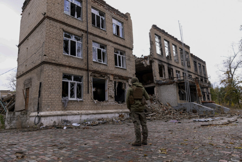 A police officer stands in front of a damaged building, amid Russia's attack on Ukraine, in the town of Avdiivka, Donetsk region, Ukraine, on 17th October, 2023