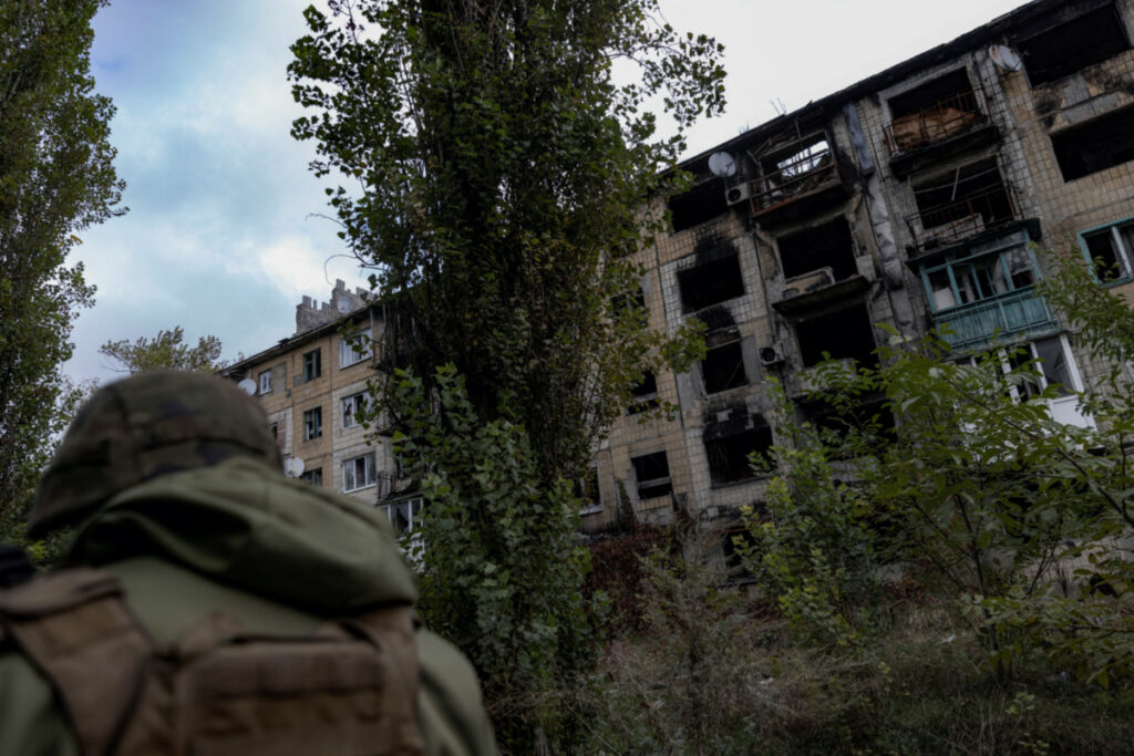 A police officer walks near a damaged residential building, amid Russia's attack on Ukraine, in the town of Avdiivka, Donetsk region, Ukraine, on 17th October, 2023.