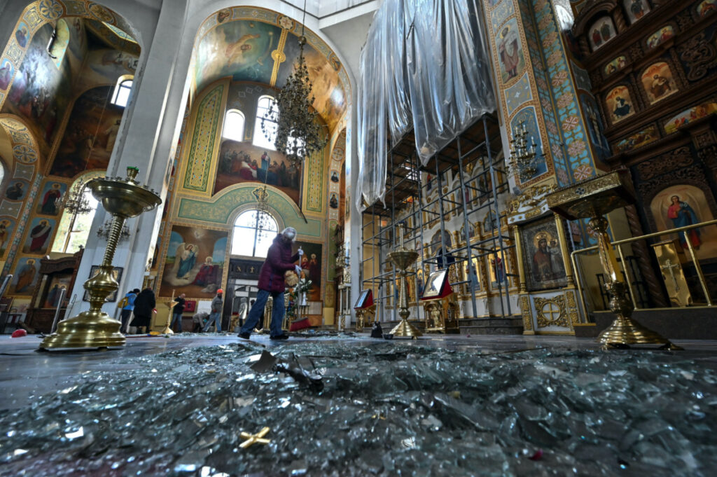 A woman removes debris inside a cathedral damaged by a Russian missile strike, amid Russia's attack on Ukraine, in Zaporizhzhia, Ukraine on 18th October, 2023