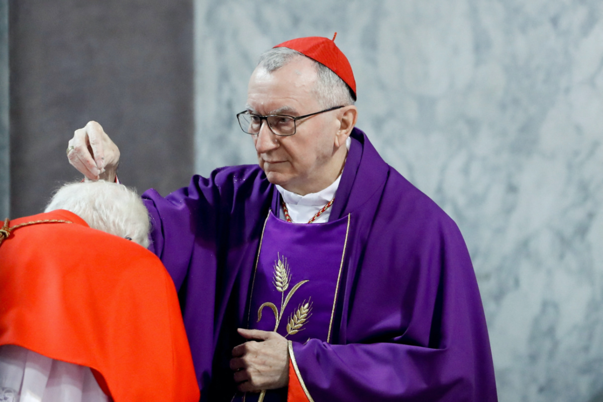 Vatican Secretary of State Cardinal Pietro Parolin puts ashes on a cardinal's head during a mass on Ash Wednesday in Rome, Italy, on 2nd March, 2022.