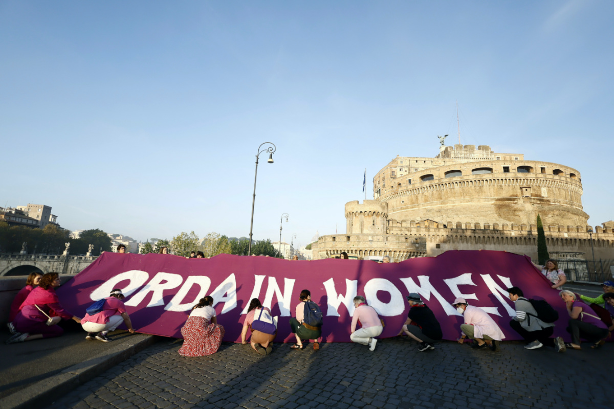 Women hold up a banner during a protest at St Angel Castle by WOC, Women Ordination Conference requesting the ordination of women to the priesthood, as Pope Francis begins a synod presiding over a mass in St Peter’s Square at The Vatican, on Wednesday, 4th October, 2023. 