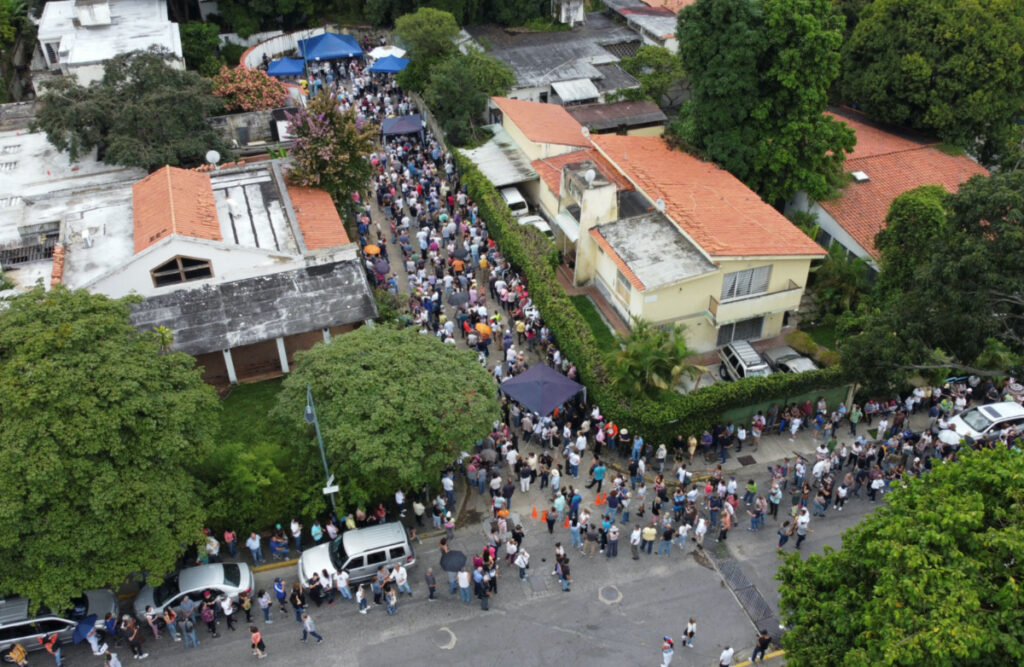 People stand in line to cast their votes in a primary to choose a unity opposition candidate to face Venezuela's President Nicolas Maduro in his probable re-election bid in 2024, in Caracas, Venezuela, on 22nd October, 2023.