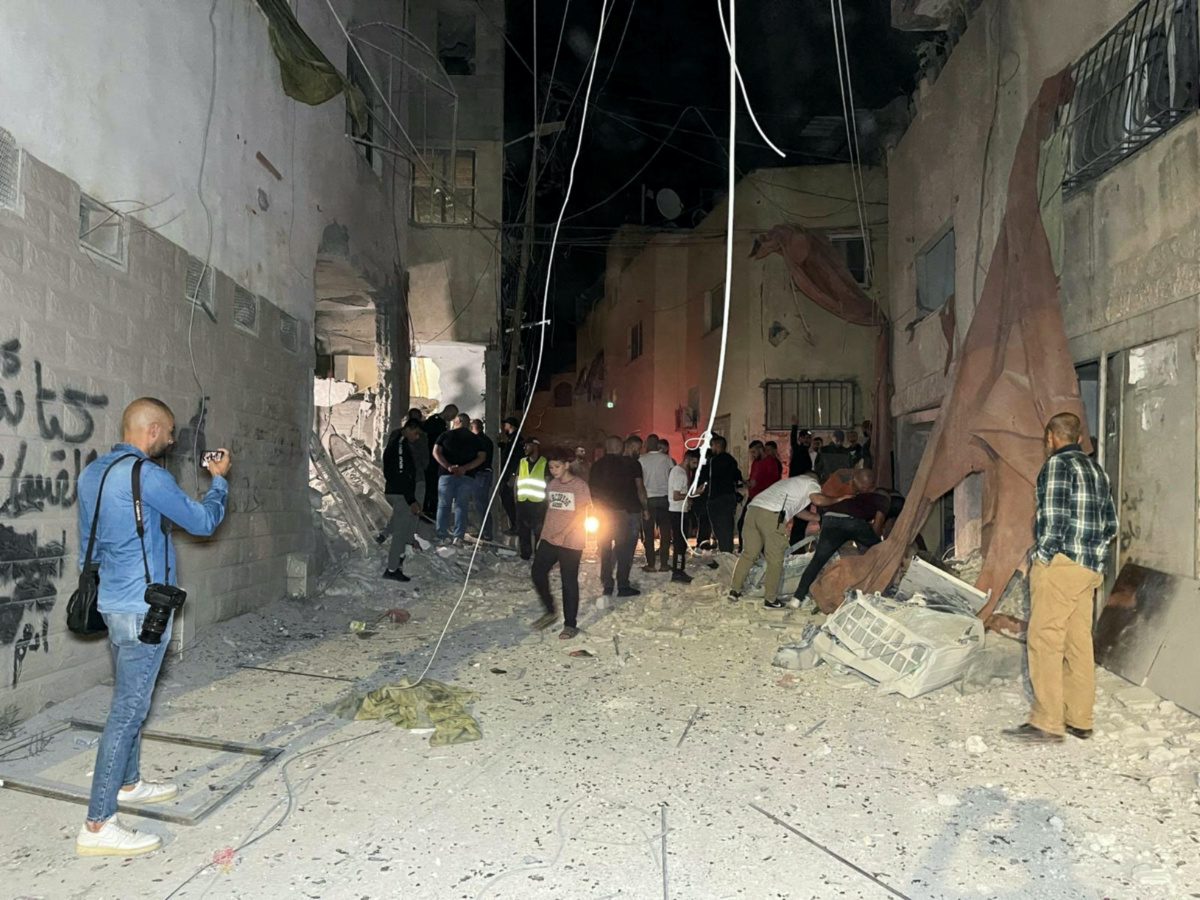 People inspect the damage after an Israeli strike hit a compound beneath a mosque that the Israeli military said was being used by militants to organize attacks, in Jenin refugee camp in the Israeli-occupied West Bank, on 22nd October, 2023