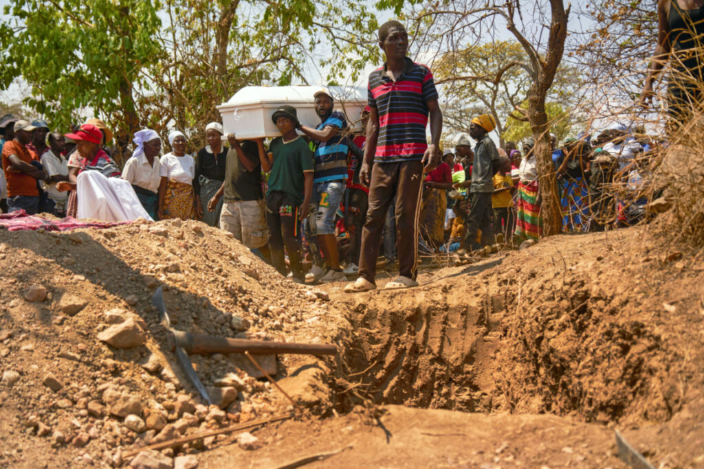 People prepare to bury one of multiple artisanal miners killed when a disused mining shaft collapsed near Chegutu, Zimbabwe, on 2nd October, 2023
