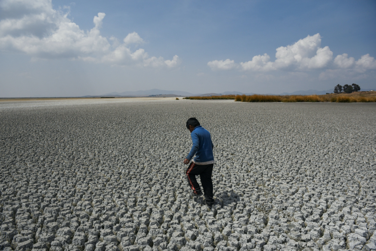 Alex Flores walks on a dry area of Lake Titicaca, Latin America's largest freshwater basin, as it is edging towards record low levels, on Cojata Island, Bolivia on 26th October, 2023
