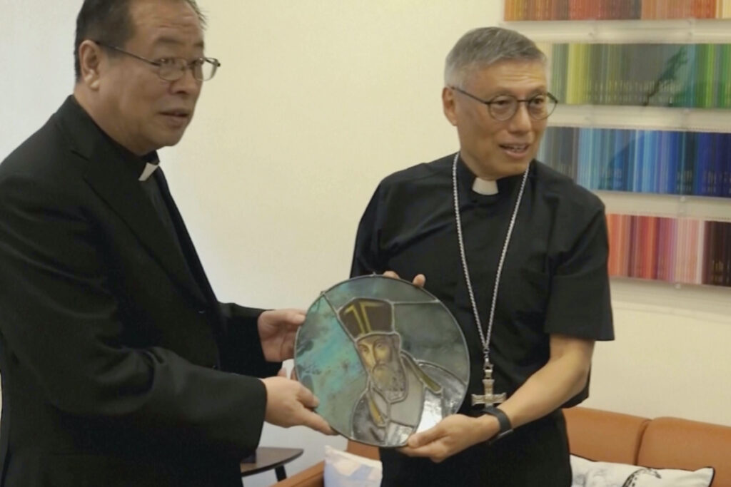 In this photo taken from video and released on 17th November, 2023 by Hong Kong Catholic Diocese, Beijing Bishop Joseph Li Shan at left and Hong Kong Bishop and Cardinal Stephen Chow exchange a gift in Hong Kong.