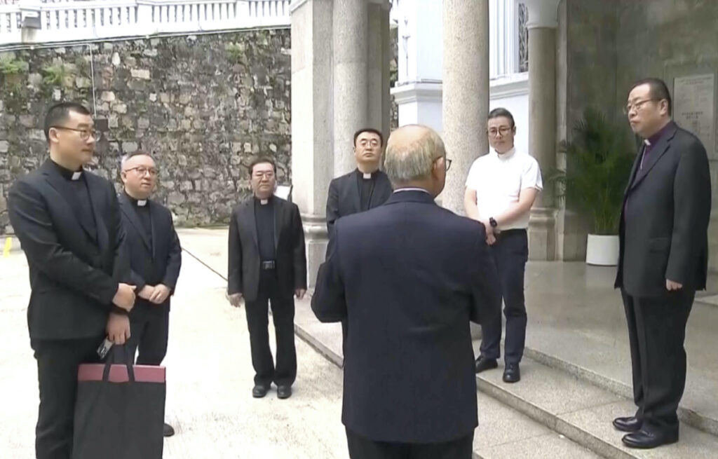 In this image taken from a video footage run by TVB, Joseph Li, the head of the Catholic church in China, right, stands outside Hong Kong's Cathedral of the Immaculate Conception in Hong Kong on Tuesday, 14th November, 2023.