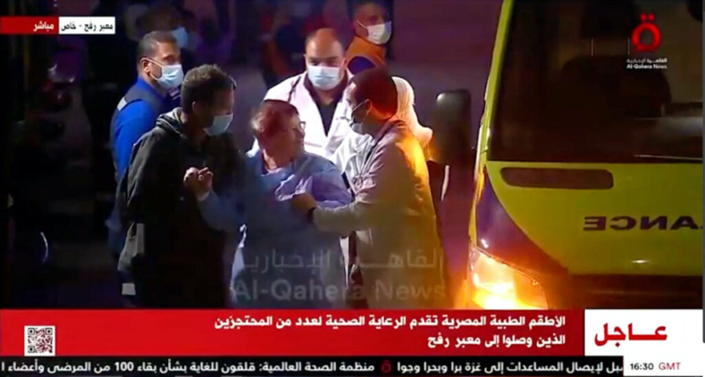 Released hostages disembark from an ambulance, as a convoy of vehicles carrying hostages abducted by Hamas militants during the 7th October attack on Israel arrives through the border crossing with Gaza, amid a hostages-prisoners swap deal between Hamas and Israel, in Egypt on 24th November, 2023.