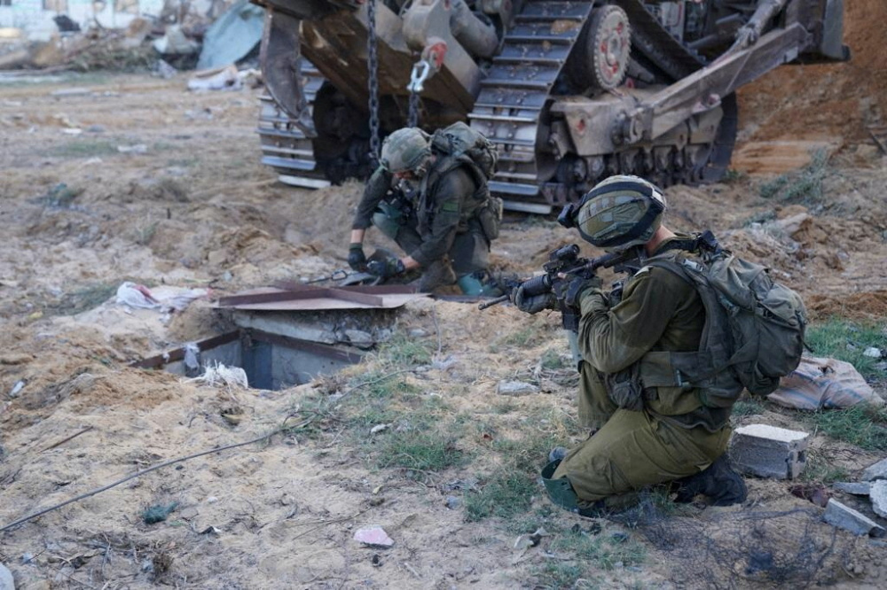 Israeli soldiers inspect the entrance to what they say is a tunnel used by militants of the Palestinian Islamist group Hamas, during a ground operation in a location given as Gaza, in this handout image released on 9th November, 2023