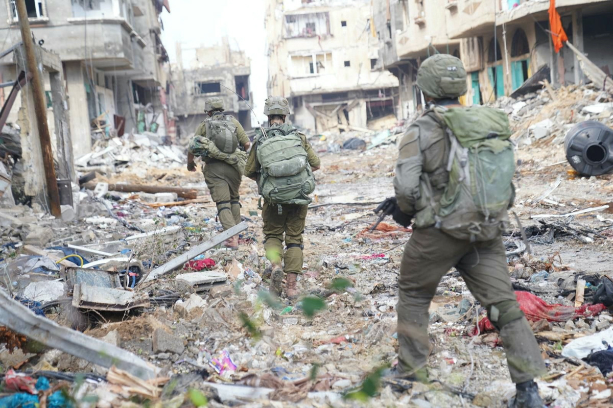 Israeli soldiers operate next to damaged buildings amid the ongoing ground operation of the Israeli army against the Palestinian Islamist group Hamas, in the Gaza Strip, in this handout image released on 18th November, 2023