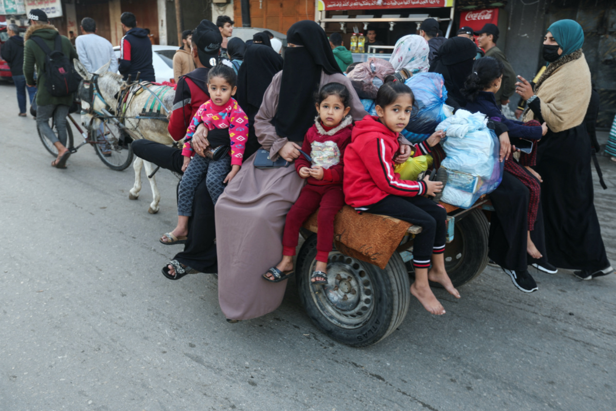 Displaced Palestinians ride on a donkey cart as they look to make their way home, during a temporary truce between Hamas and Israel, in Khan Younis in the southern Gaza Strip, on 24th November, 2023. 