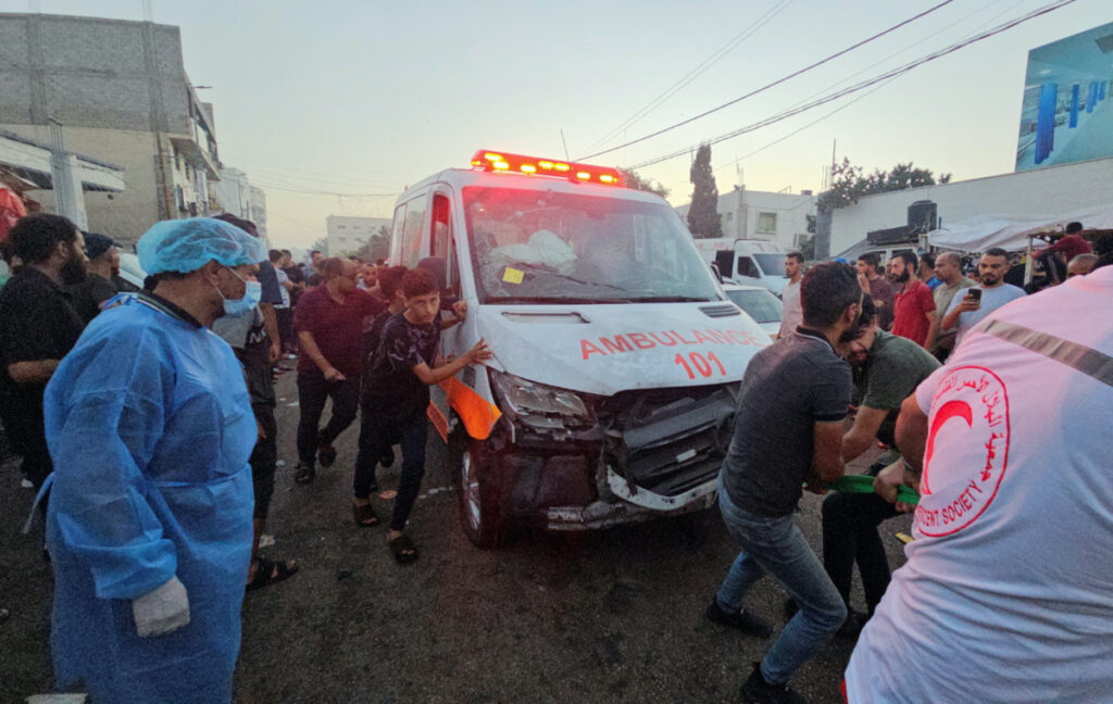 Palestinians pull an ambulance after a convoy of ambulances was hit, at the entrance of Shifa hospital in Gaza City, on 3rd November, 2023.