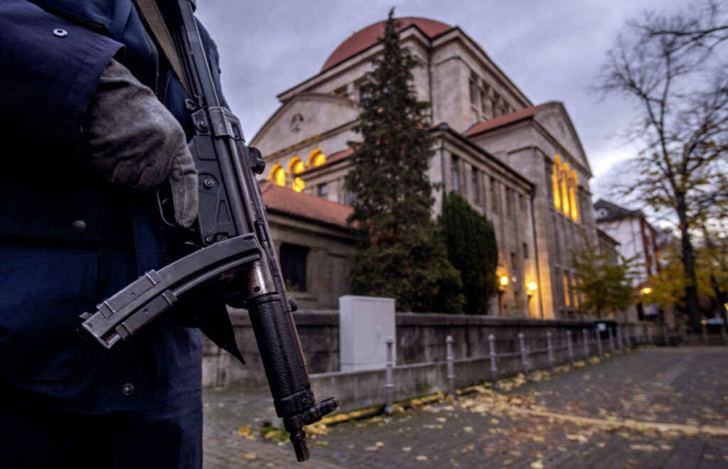 A German police officer stands guard in front of the synagogue in Frankfurt, Germany, early Wednesday, on 8th November, 2023.
