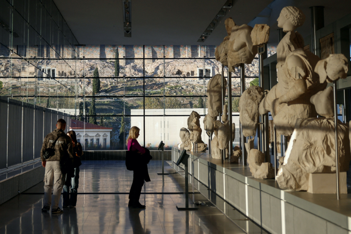 People visit the Parthenon Gallery, designed to accommodate the sculptures of the Parthenon, at the Acropolis Museum in Athens, Greece, on 27th November, 2023. 