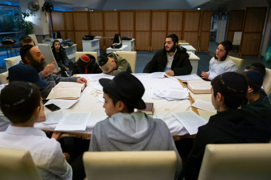 Young refugees from Israel listen to a rabbi in a Yashiva in a Jewish refugee camp in Balatonoszod, Hungary, Tuesday, on 7th November, 2023