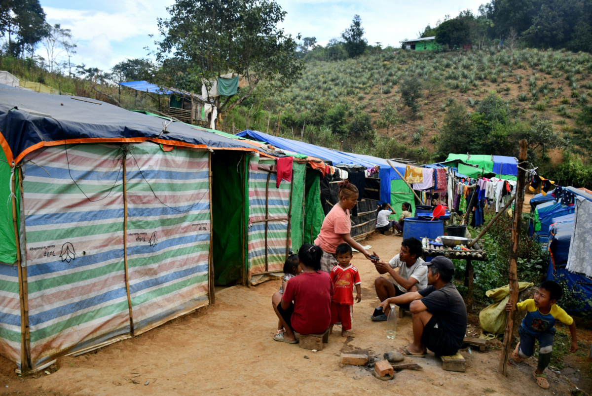 People who fled Myanmar sit outside their sheds in a relief camp at the border village of Zokhawthar, Champhai district, in India's north-eastern state of Mizoram, India, on 15th November, 2023