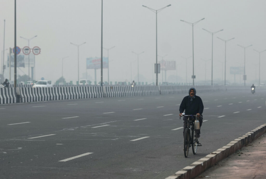 A man rides a cycle amidst the morning smog in New Delhi, India, on 7th November, 2023