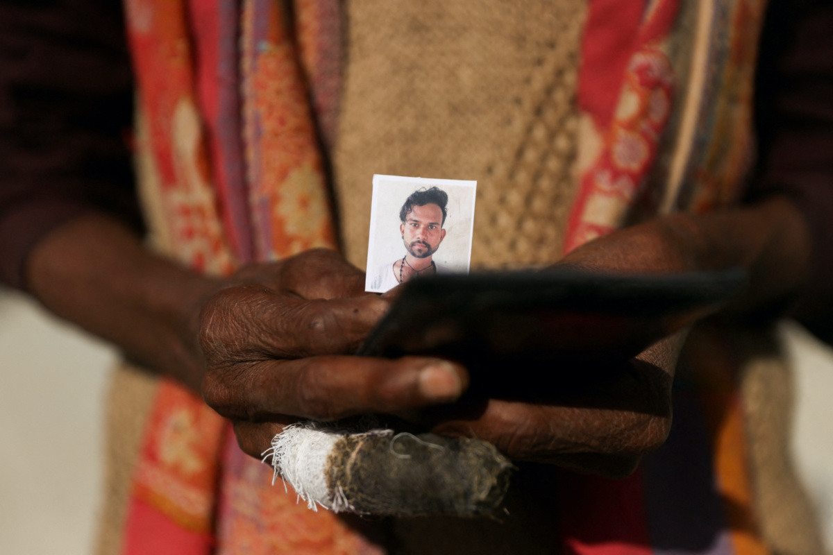 Chowdhry stands near the site of the collapse of an under-construction tunnel holding the picture of his son Manjeet who is one of the workers trapped inside the tunnel as rescue operations of the trapped workers are underway, in Uttarkashi, in the northern state of Uttarakhand, India, on 26th November, 2023