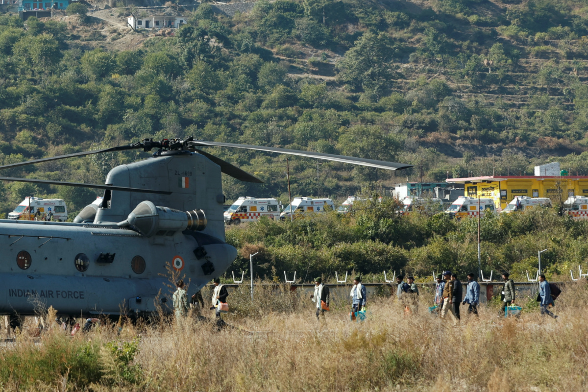 Workers, who were rescued from a tunnel which collapsed in Uttarkashi, walk to board an Indian Air Force's Chinook helicopter to be airlifted to AIIMS Rishikesh hospital, in Chinyalisaur, in the northern state of Uttarakhand, India, on 29th November, 2023.