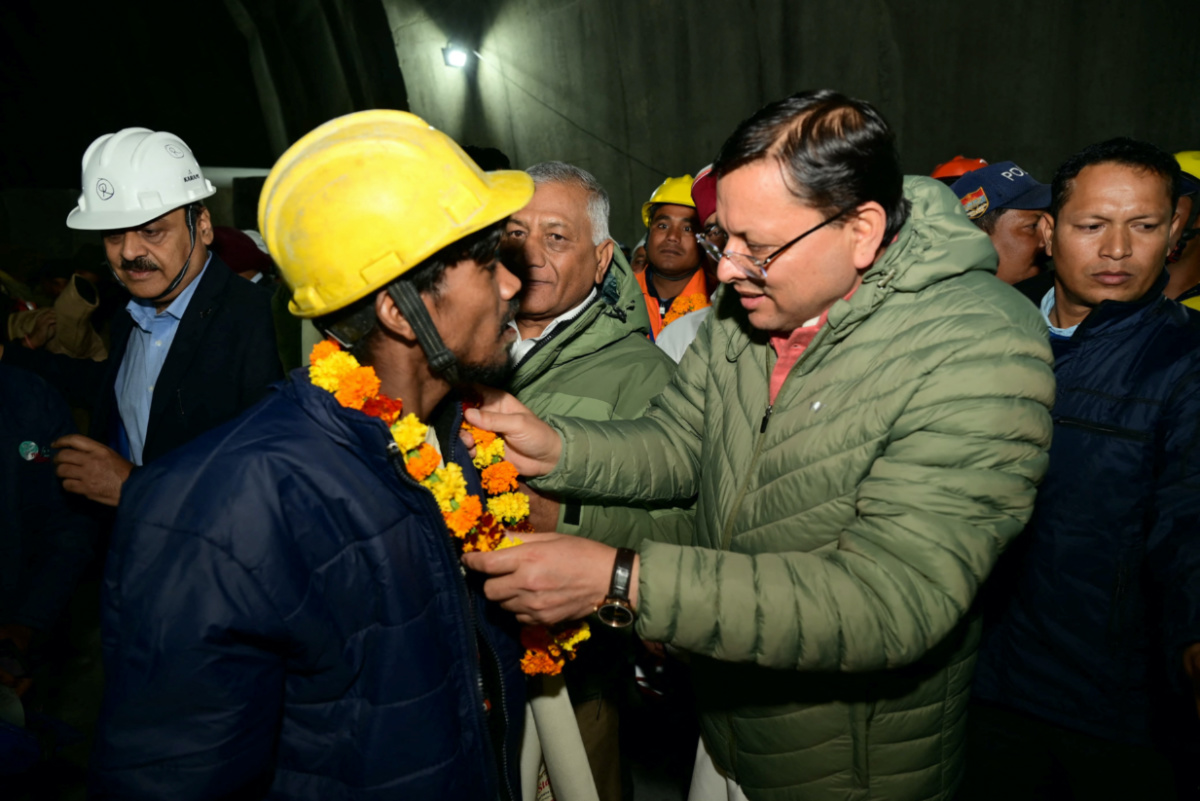 Pushkar Singh Dhami, Chief Minister of the northern state of Uttarakhand, greets a worker after he was rescued from the collapsed tunnel site in Uttarkashi, Uttarakhand, India, on 28th November, 2023