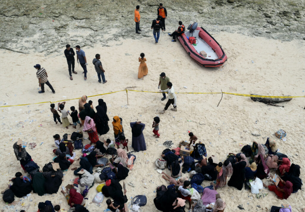 Rohingya Muslims rest after landing on a beach in Sabang, Aceh province, Indonesia, on 22nd November, 2023.