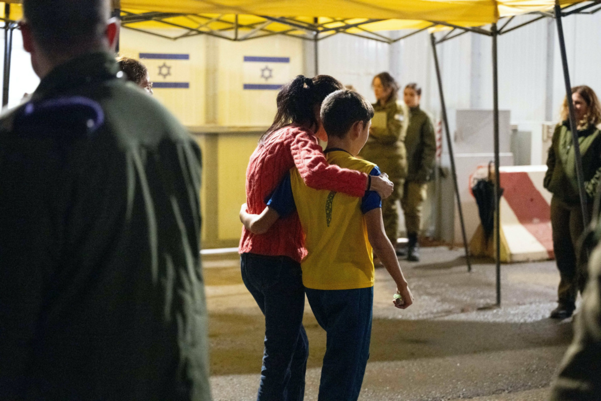 Eitan Yahalomi, 12, walks with his mother at the Kerem Shalom border crossing, after being released from Gaza where he was kept hostage following the 7th October attack by Palestinian militant group Hamas, in Israel, in this handout image obtained by Reuters on 28th November, 2023.
