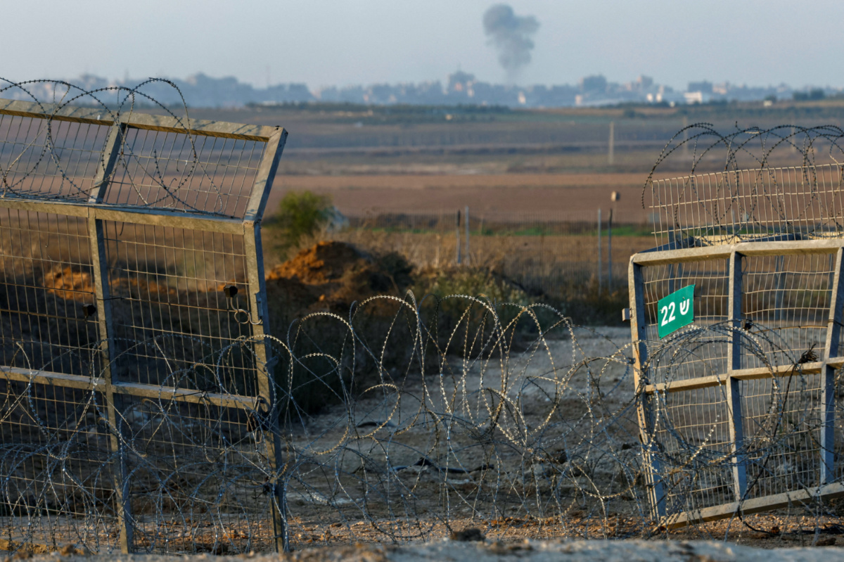 Smoke rises as seen from the broken fence in Kfar Aza where Hamas gunmen entered during the October 7th attack, in southern Israel, on 5th November, 2023