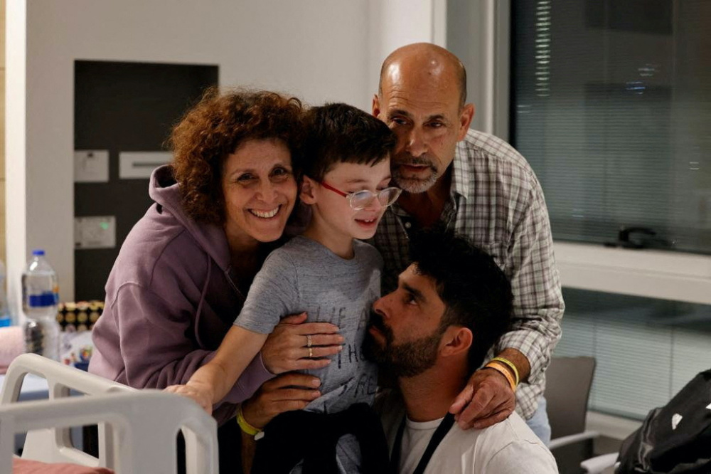 Ohad Munder, 9-year-old, reacts as he meets with his family members after he returned to Israel to the designated complex at the Schneider Children's Medical Center, during a temporary truce between Hamas and Israel, in Petah Tikva, Israel, in this handout picture released on 25th November, 2023. 