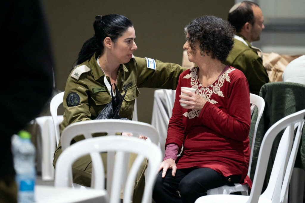 Shoshan Haran, a released Israeli hostage, speaks with an Israeli soldier shortly after her arrival in Israel on 25th November, after being held hostage by the Palestinian militant group Hamas in the Gaza Strip, at an unknown location in Israel, in this handout picture released by the Israeli Prime Minister's Office on 26th November, 2023.