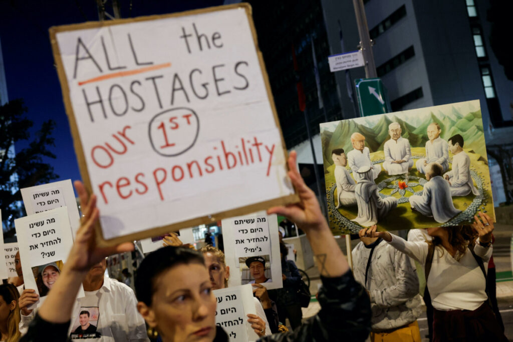 Protesters hold signs demanding the liberation of hostages who are being held in the Gaza Strip after they were seized by Hamas gunmen on 7th October, in Tel Aviv, Israel, on 21st November, 2023.