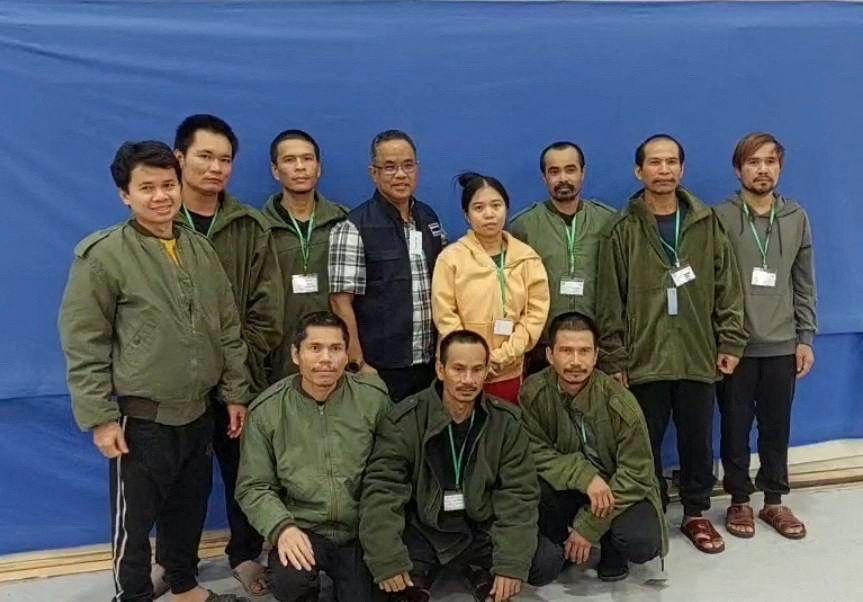 Thai workers taken hostage by Hamas and later released as part of a deal between Israel and Palestinian Islamist group Hamas, pose with a member of Thai mission after a medical checkup, in Tel Aviv, Israel, in this handout image released on 25th November, 2023.
