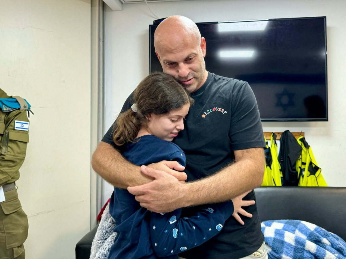 Hila Rotem-Shoshani, who was abducted by Hamas gunmen during the October 7 attack on Israel, meets a family member after being released as part of a hostages-prisoners swap deal between Hamas and Israel amid a temporary truce, at an unknown location in Israel, in this handout image released on 26th November, 2023.  
