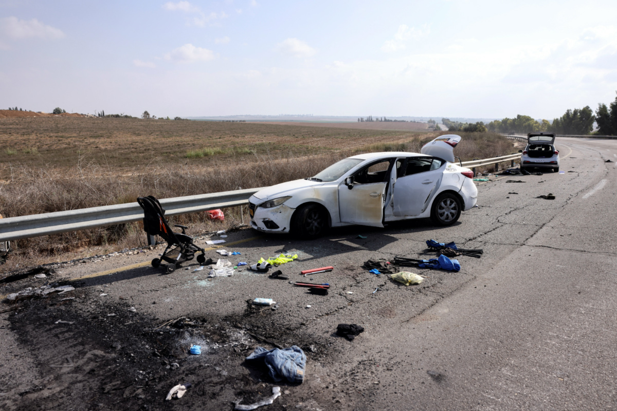 Personal belongings including a child's pram are seen on the road next to a car days after a mass infiltration by Hamas gunmen from the Gaza Strip, near Kibbutz Kfar Aza, in southern Israel, on 10th October, 2023
