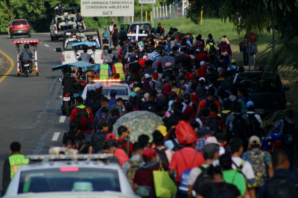 Migrants walk along the road in a caravan in an attempt to reach the U.S border, in Tapachula, Mexico, on 5th November, 2023