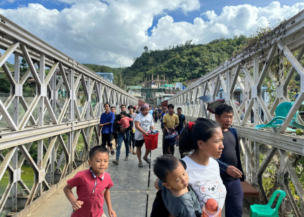 People who fled Myanmar carry their belongings across a bridge that connects Myanmar and India at the border village of Zokhawthar, Champhai district, in India's north-eastern state of Mizoram, India, on 15th November, 2023