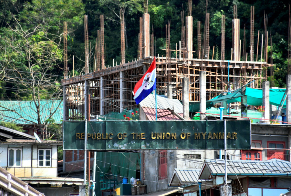 A flag of one of the Myanmar rebel forces is installed next to an under-construction structure in Myanmar's Khawmawi village on the India-Myanmar border as seen from Zokhawthar village in Champhai district of India's northeastern state of Mizoram, India, on 14th November, 2023