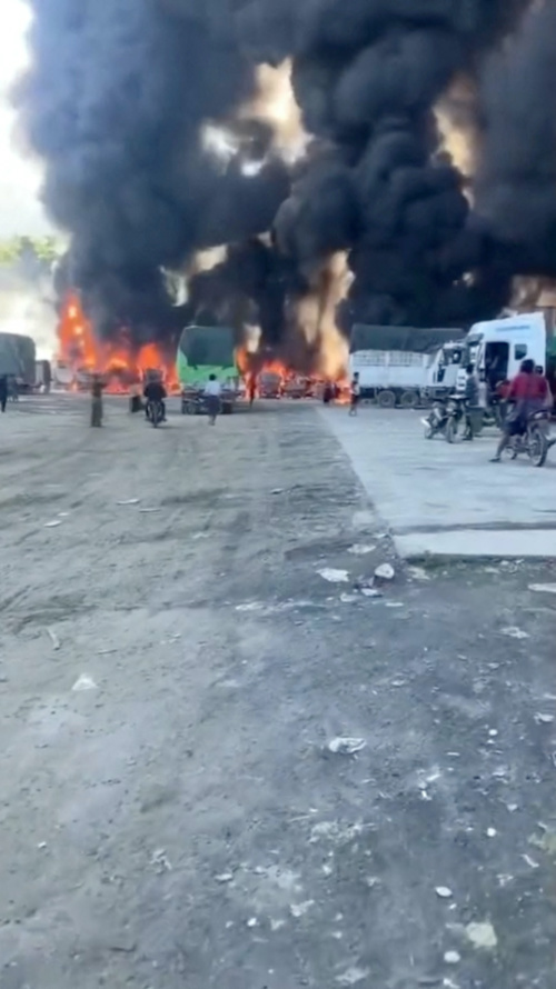 Smoke rises as a convoy of trucks burn near the Myanmar-China border, near Muse, Myanmar, in this screen grab obtained from a social media video released on 23rd November, 2023.