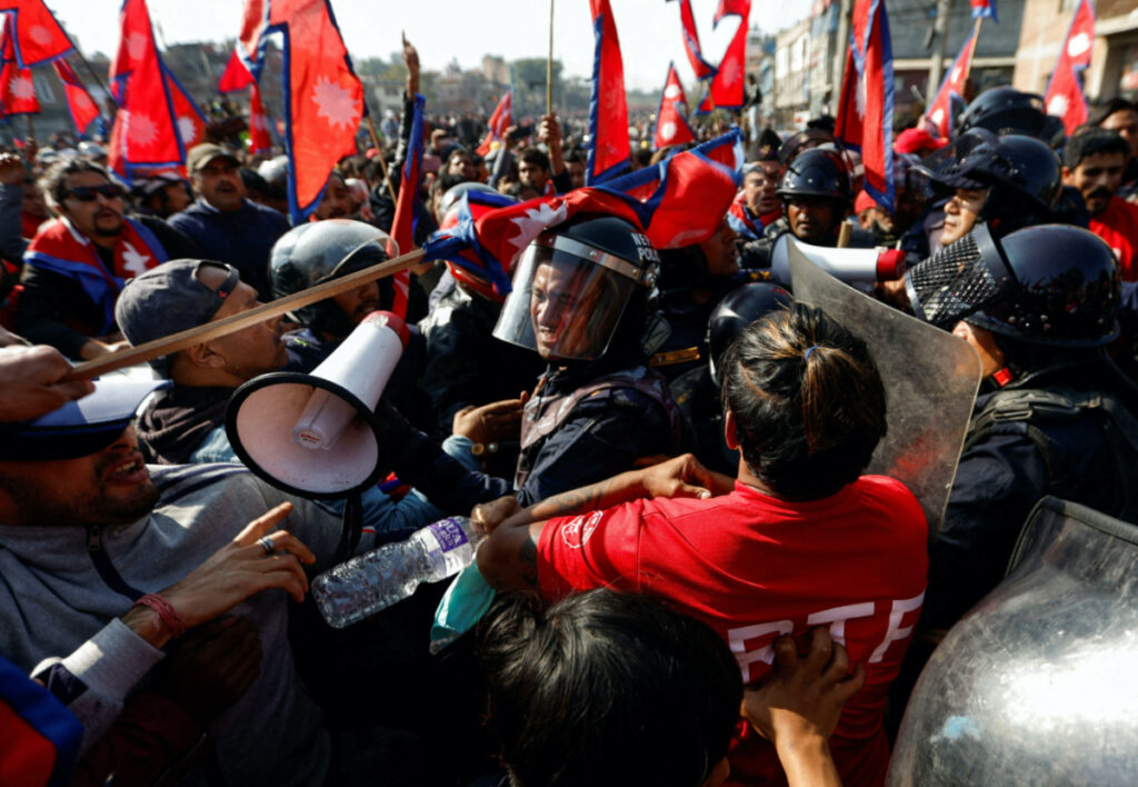 A riot police personnel gets a hit on his helmet during the clash with Pro-monarchist protesters as they protest demanding the restoration of Nepal's monarchy, which was abolished in 2008, saying the governments have failed to make any significant changes in Kathmandu, Nepal, on 23rd November, 2023.
