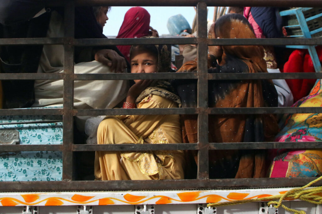 An Afghan girl along with her family sits in a truck as they head back to Afghanistan from Pakistan, at the Friendship Gate of Chaman Border Crossing along the Pakistan-Afghanistan Border in Balochistan Province, in Chaman, Pakistan, on 8th November, 2023