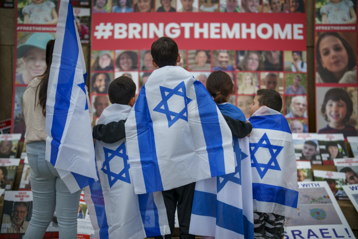 Children look at photographs of kidnapped Israelis during a rally joined by hundreds in solidarity with Israel and those held hostage in Gaza, in Bucharest, Romania, on 2nd November, 2023.