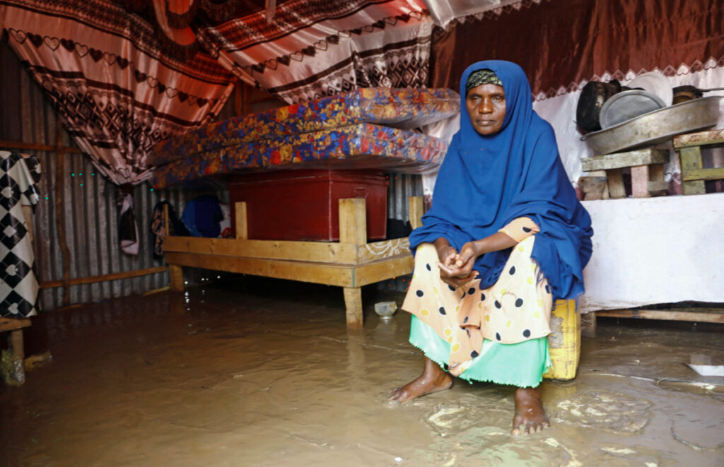 Fatima Abdi, 50, an internally displaced Somali woman sits inside her flooded makeshift shelter, following heavy rains at the Al Hidaya camp for the internally displaced people on the outskirts of Mogadishu, Somalia, on 6th November, 2023
