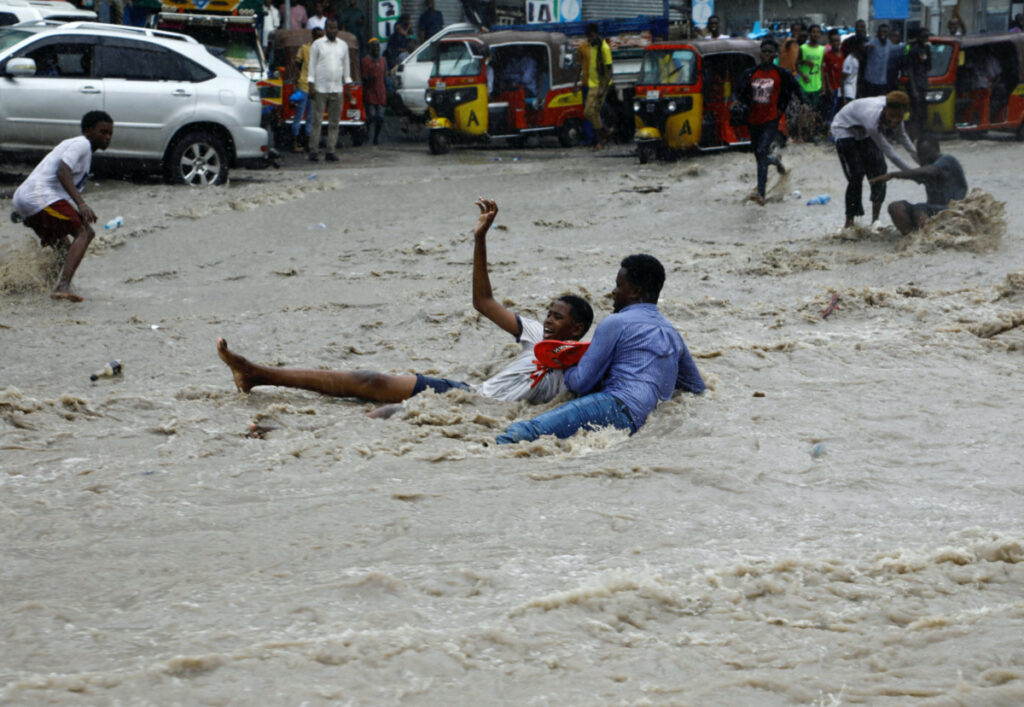 A man attempts to rescue a boy from raging flood waters following heavy rains in Mogadishu, Somalia, on 9th November, 2023.