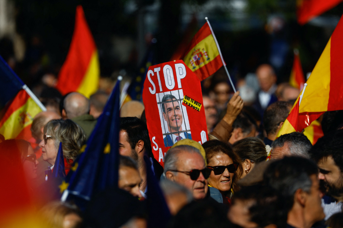People take part in a protest after Spain's socialists reached a deal with the Catalan separatist Junts party for government support, which includes amnesties for people involved with Catalonia's failed 2017 independence bid, at Cibeles square in Madrid, Spain, on 18th November, 2023. 